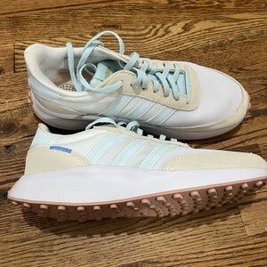 White and blue women’s Adidas tennis shoes.  Size 8.5. Never worn
